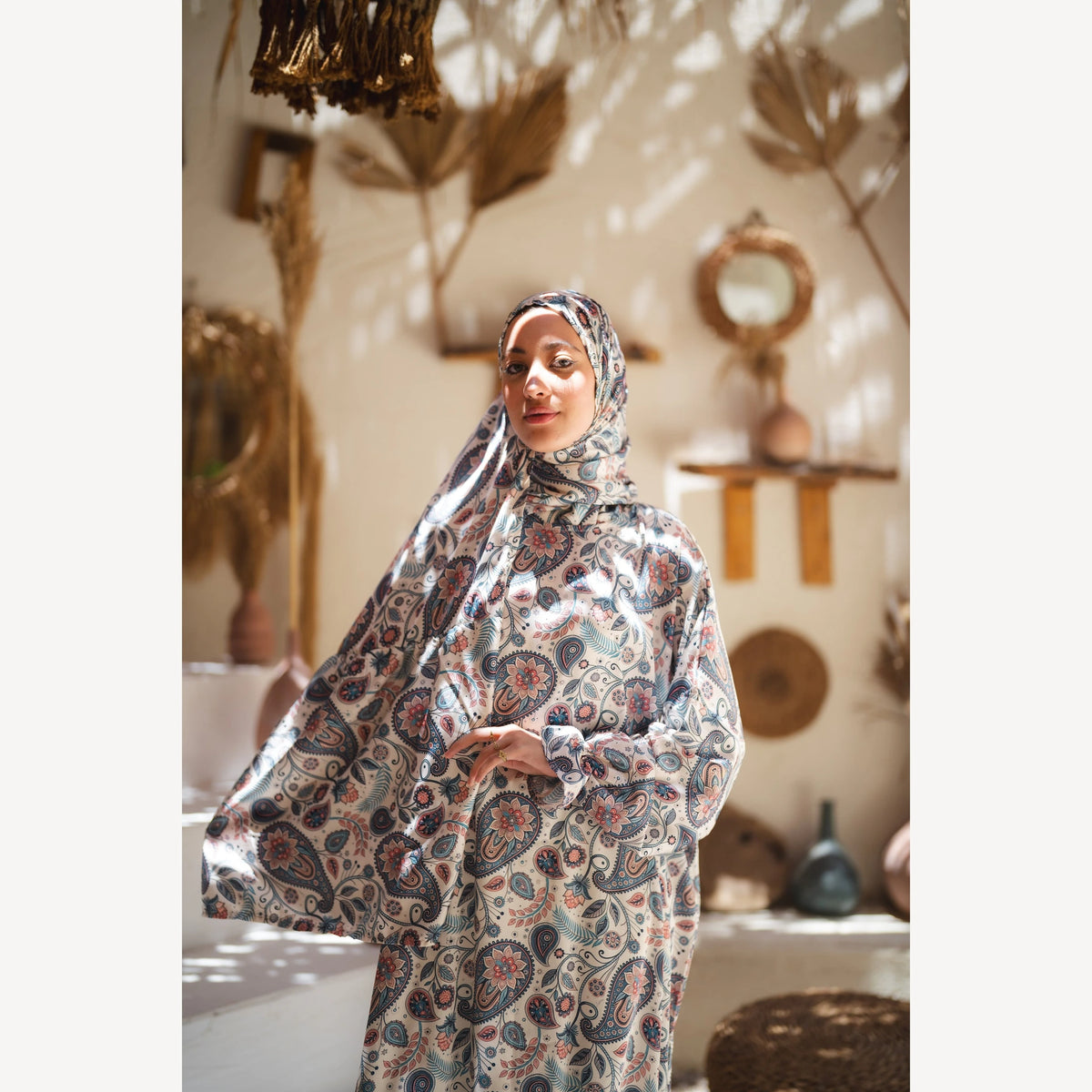 Tallah satin Isdal in cream navy rust paisley, closer front view with one sleeve extended.