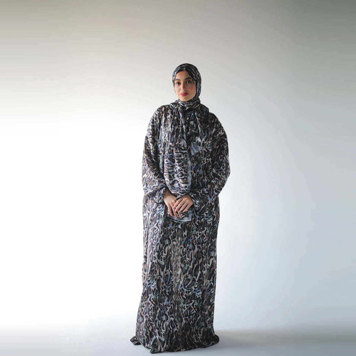 Multicolour satin Isdal with black abstract markings and muted blue and grey accents, full-length front view with hands together.