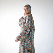 Multicolour satin Isdal with pastel blue, peach and green floral medallions on black, closer side view.