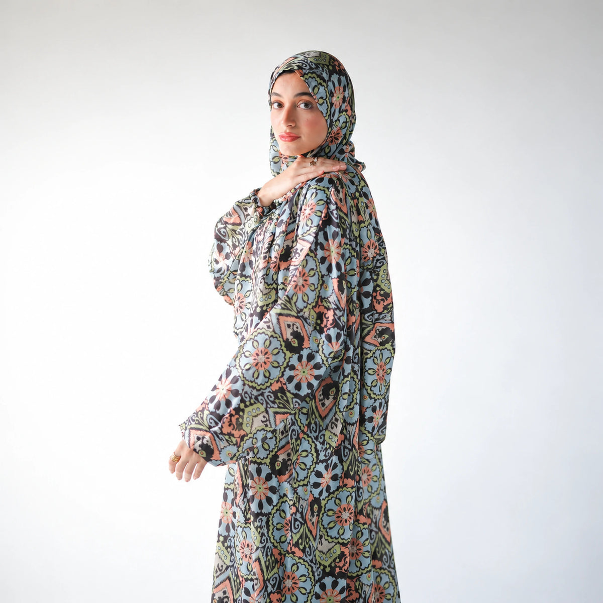 Multicolour satin Isdal with pastel blue, peach and green floral medallions on black, closer side view.