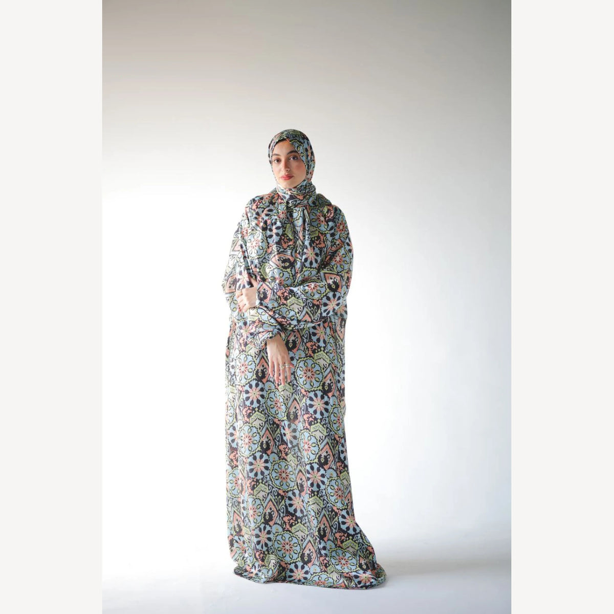 Tallah satin Isdal in navy green cream medallion, full-length three-quarter view with hands together.