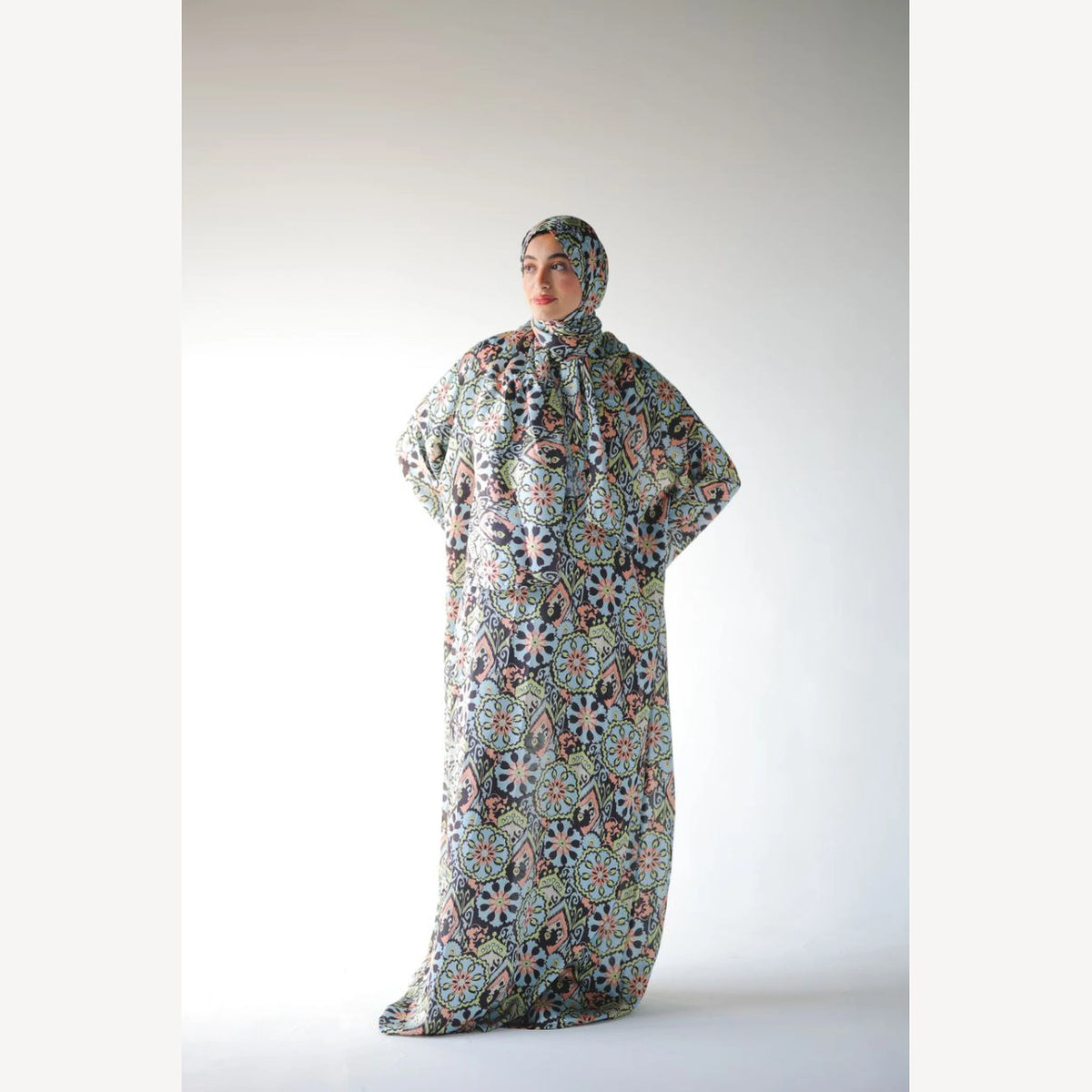 Tallah satin Isdal in navy green cream medallion, full-length front view with hands at waist.