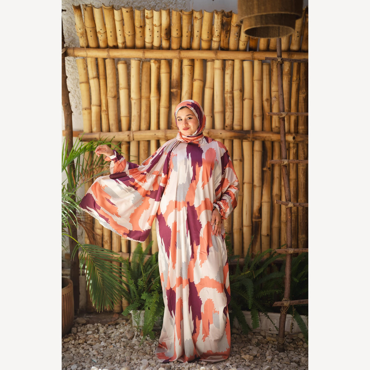 Tallah satin Isdal in orange plum cream brushstroke, full-length front view with one sleeve extended.