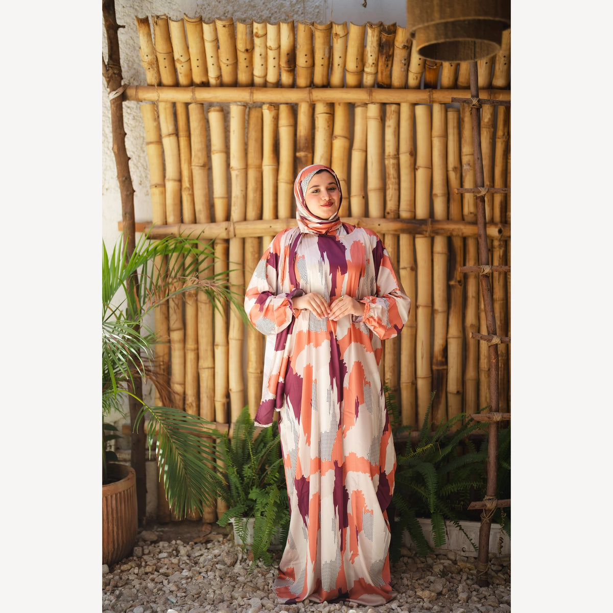 Tallah satin Isdal in orange plum cream brushstroke, full-length front view with hands together.