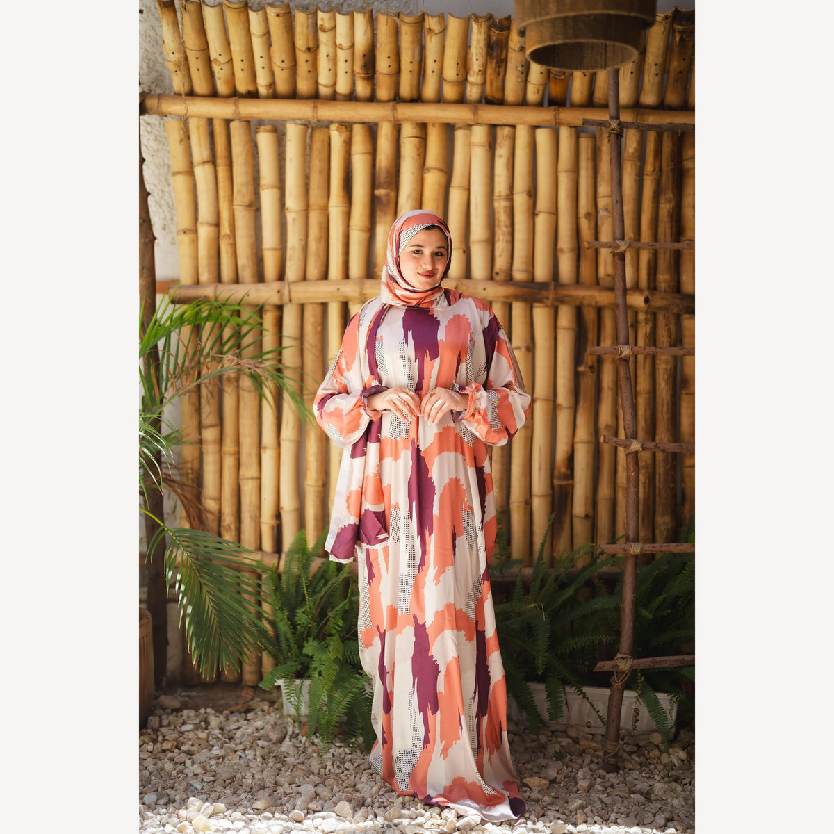 Tallah satin Isdal in orange plum cream brushstroke, full-length front view with hands at waist.