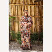 Tallah satin Isdal in red cream black patchwork, full-length front view with hands together.