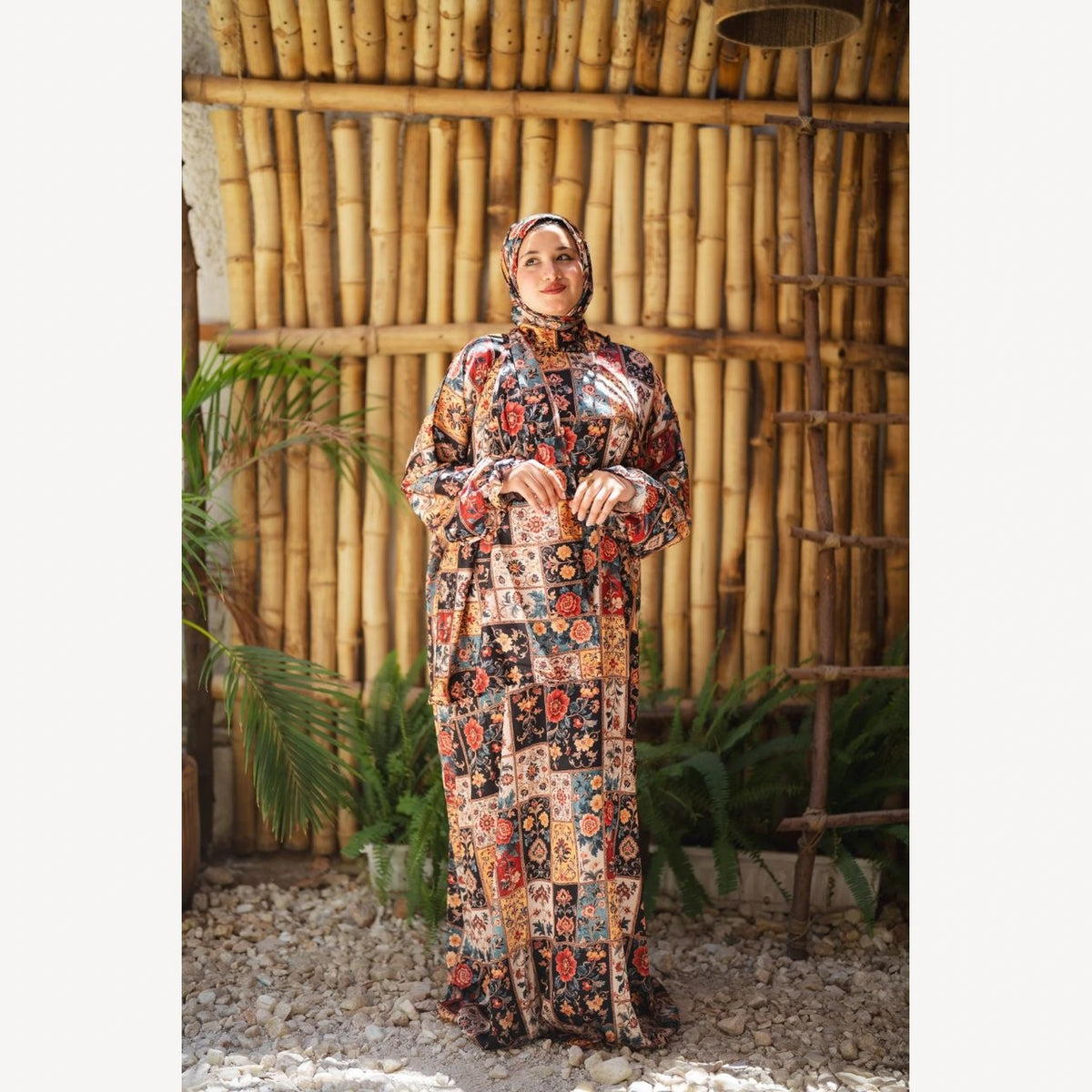 Tallah satin Isdal in red cream black patchwork, full-length front view with hands together.